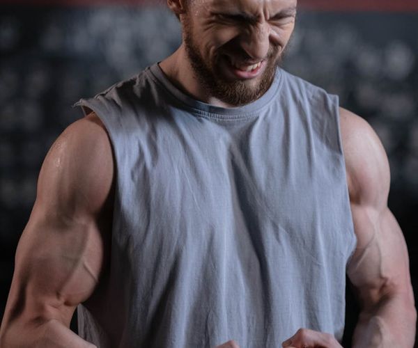 Athletic man showing results of regular strength training focus